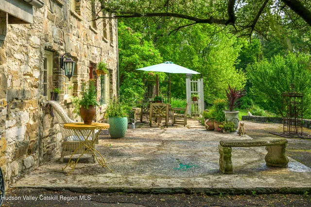 a view of a patio with table and chairs under an umbrella