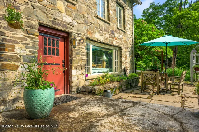 a front view of a house with outdoor seating