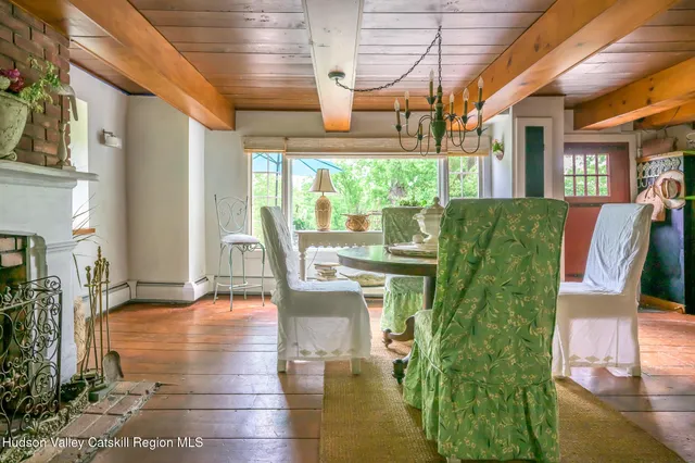 a view of a living room with a floor to ceiling window and wooden floor