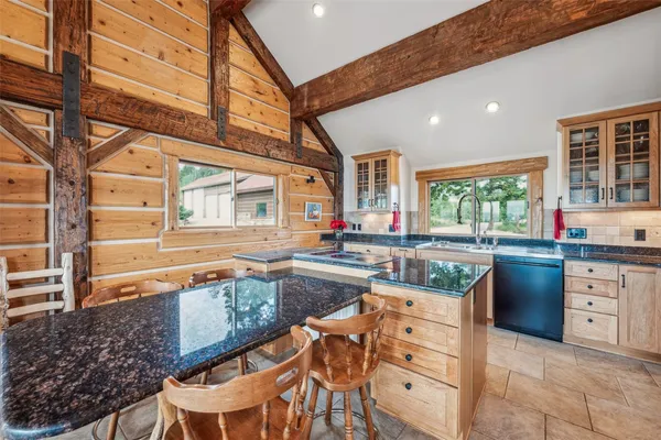 a kitchen with stainless steel appliances granite countertop a stove and cabinets