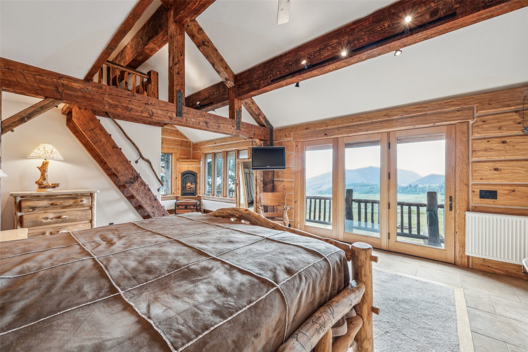 733 Spring Creek Ranch Road Silverthorne, CO 80498 - Photo 14 of 34 a bed sitting in a spacious bedroom next to a large window