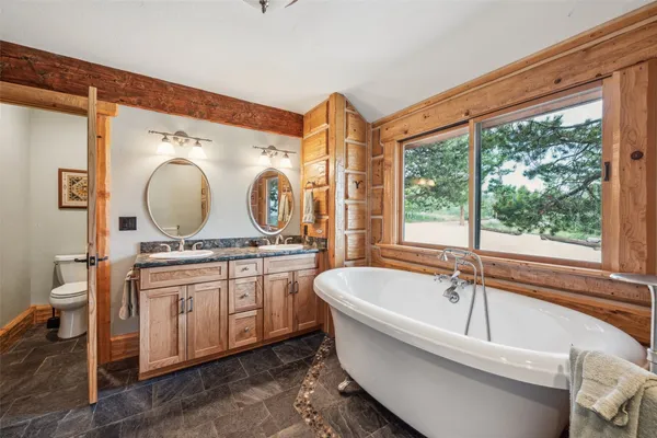 a bathroom with a granite countertop sink and a large mirror