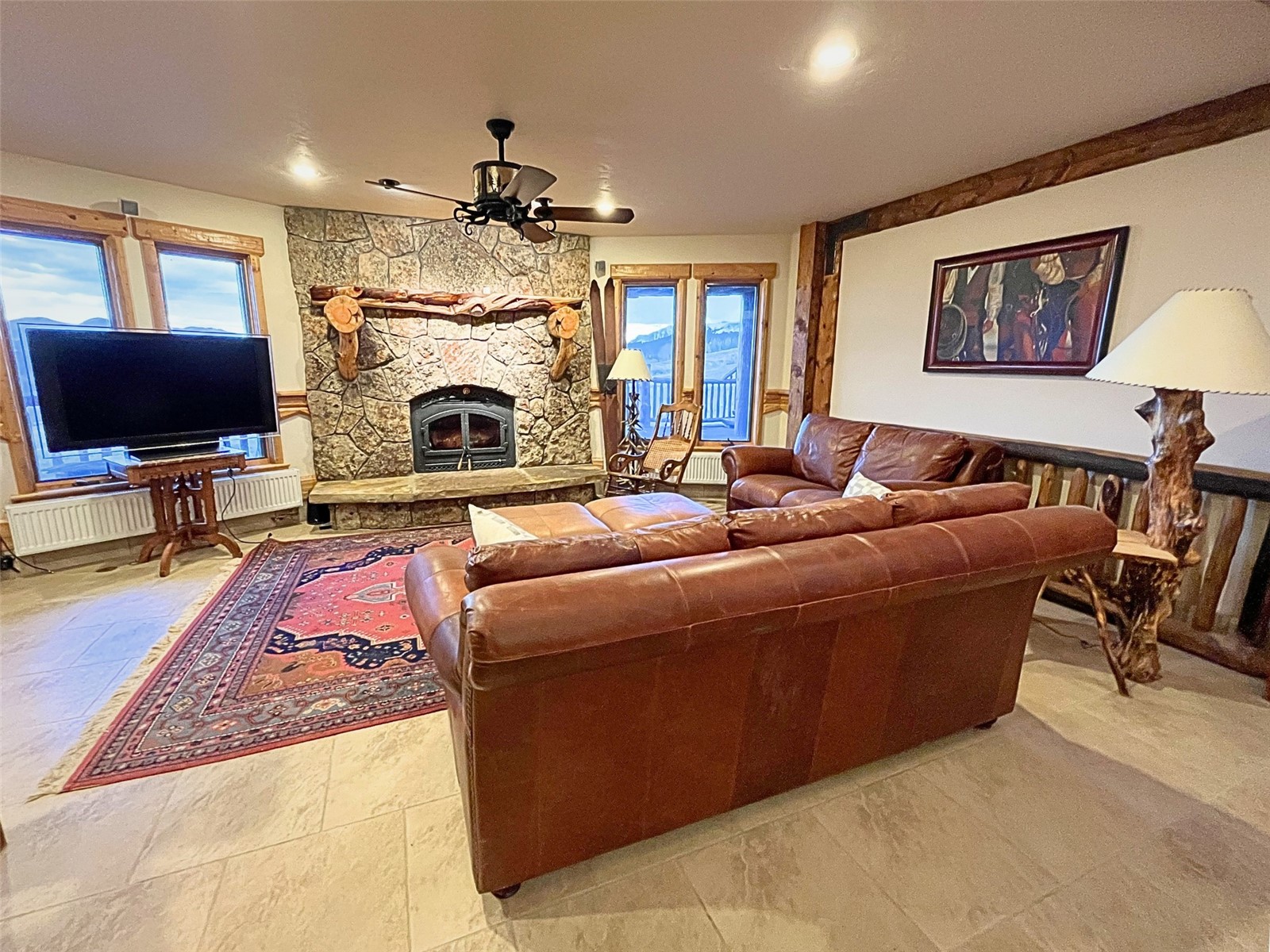 733 Spring Creek Ranch Road Silverthorne, CO 80498 - Photo 20 of 34 a living room with furniture a fireplace and a flat screen tv