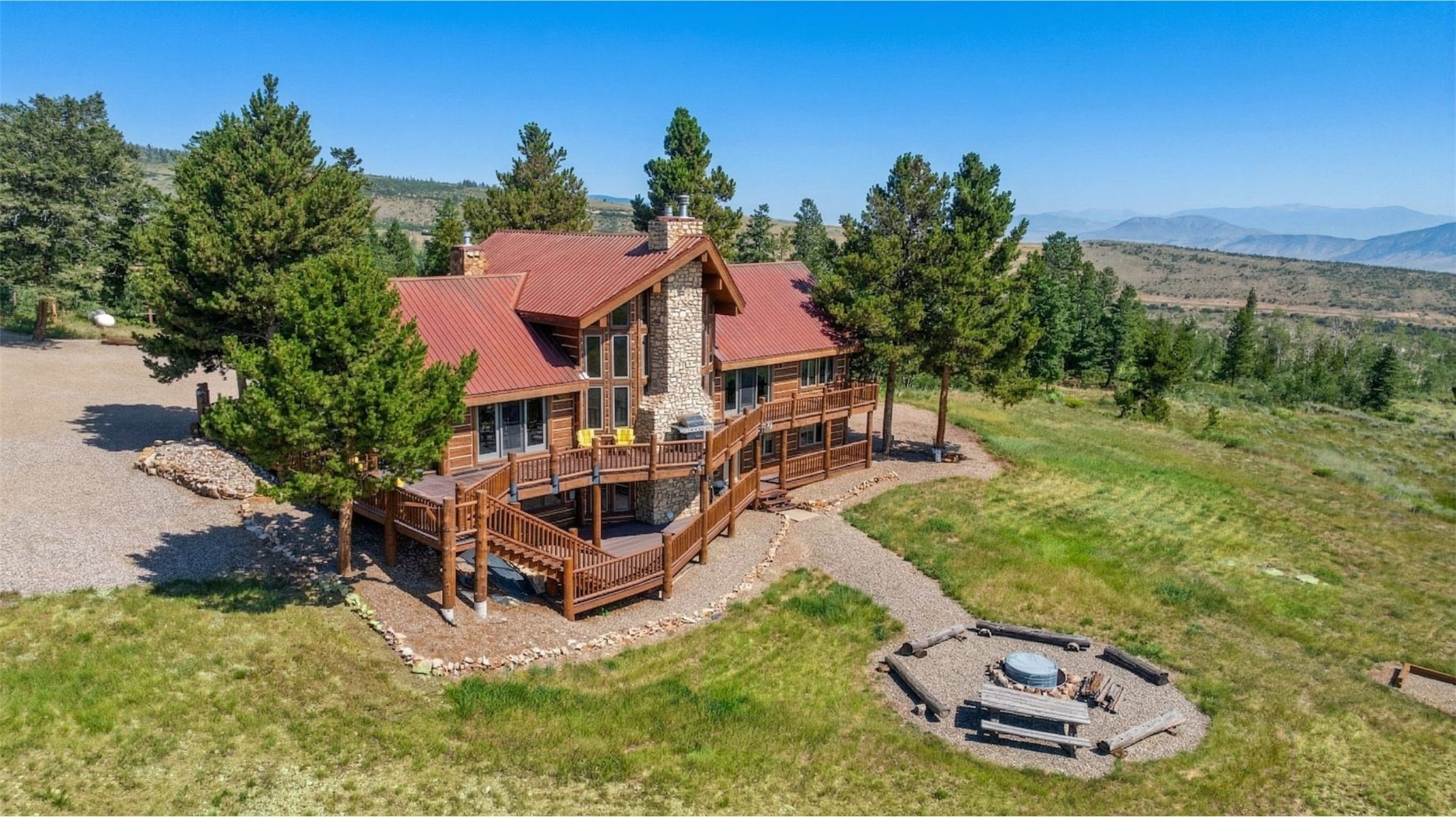 733 Spring Creek Ranch Road Silverthorne, CO 80498 - Photo 2 of 34 an aerial view of a house with a garden and large trees