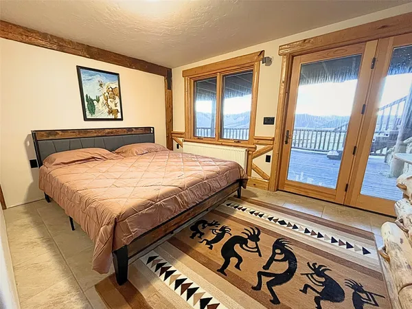 a bedroom with a bed next to a window