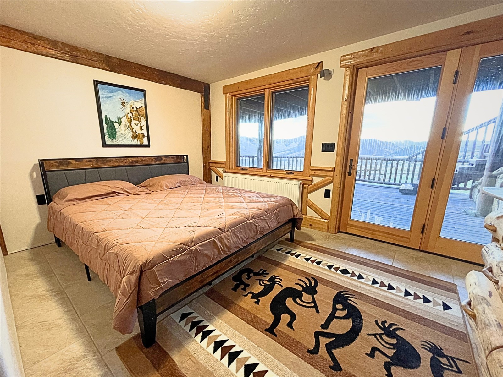 733 Spring Creek Ranch Road Silverthorne, CO 80498 - Photo 21 of 34 a bedroom with a bed next to a window