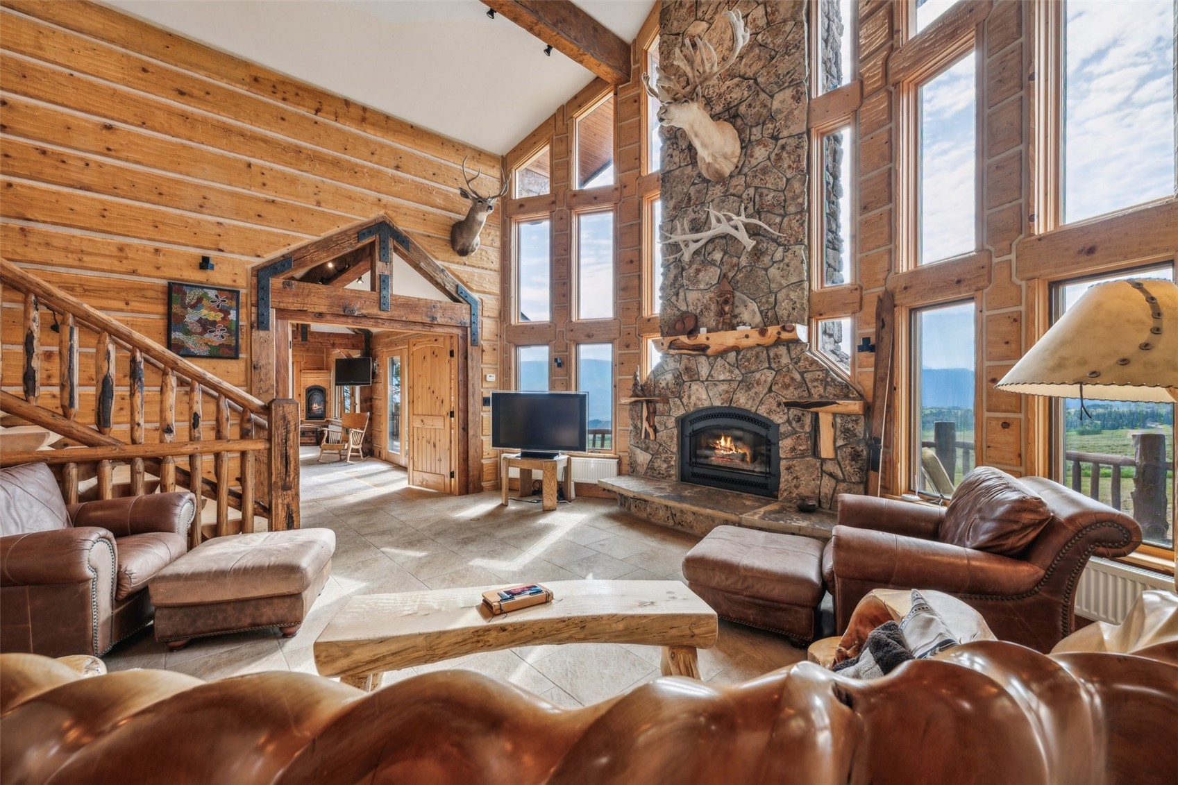 733 Spring Creek Ranch Road Silverthorne, CO 80498 - Photo 5 of 34 a living room with furniture a fireplace and a large window
