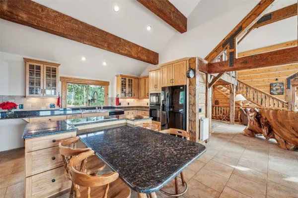 a kitchen with stainless steel appliances granite countertop a sink and cabinets