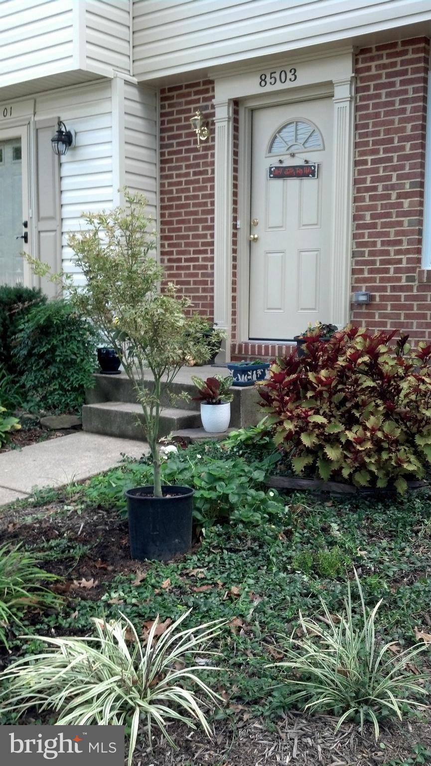 8503 Golden Ridge Court Lorton, VA 22079 - Photo 2 of 27 a front view of a house with garden