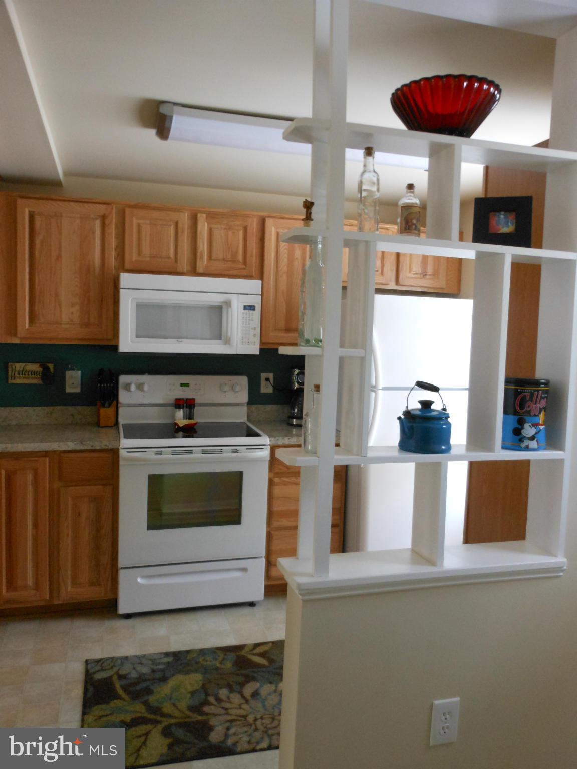 8503 Golden Ridge Court Lorton, VA 22079 - Photo 11 of 27 a kitchen with stainless steel appliances granite countertop a stove a sink and a microwave
