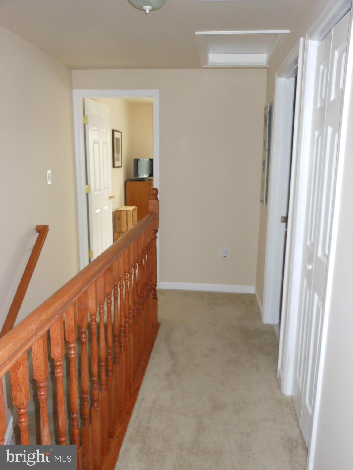 8503 Golden Ridge Court Lorton, VA 22079 - Photo 12 of 27 a view of a hallway with wooden floor and stairs