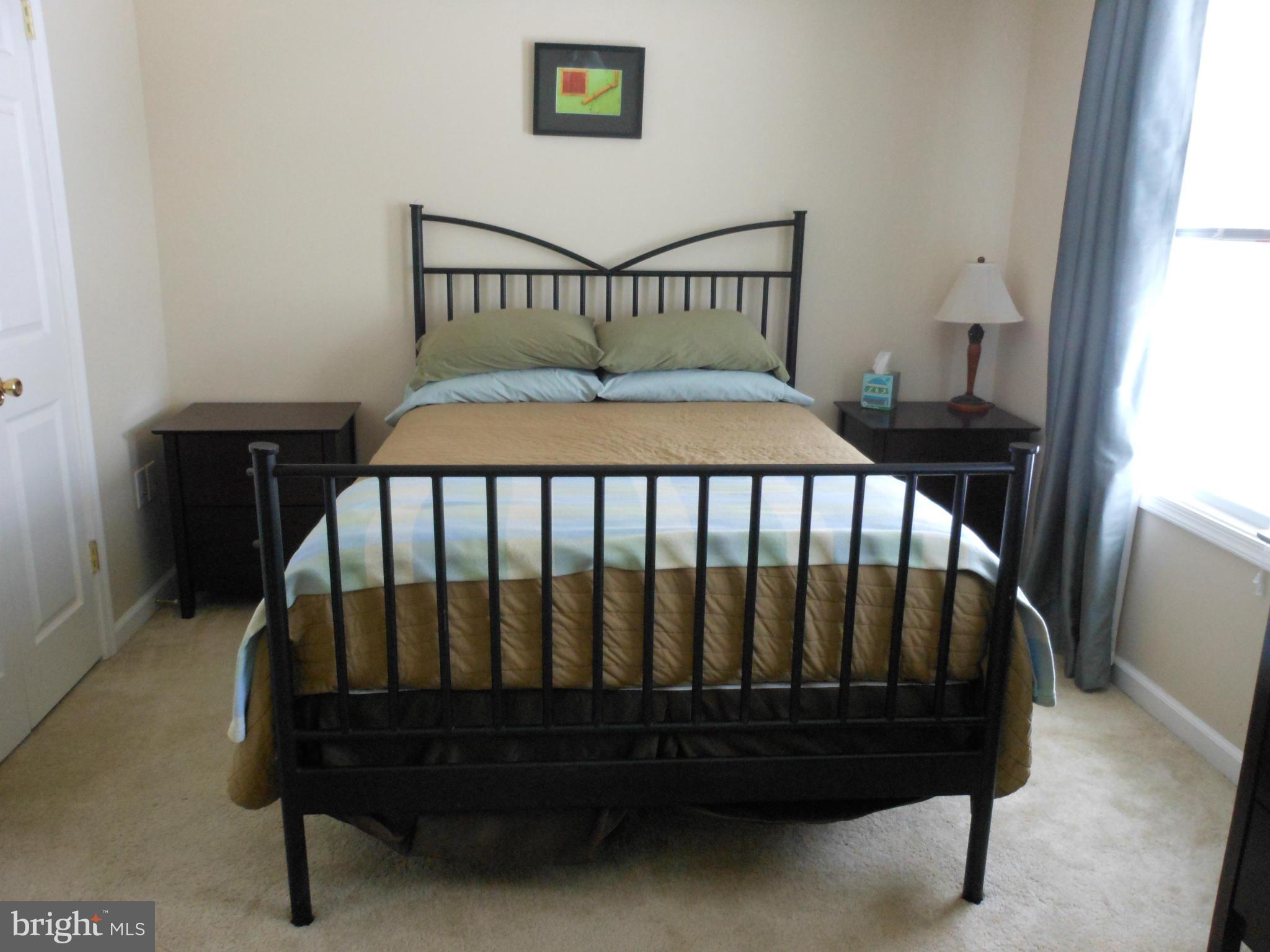 8503 Golden Ridge Court Lorton, VA 22079 - Photo 14 of 27 a bed sitting in a bedroom next to a window