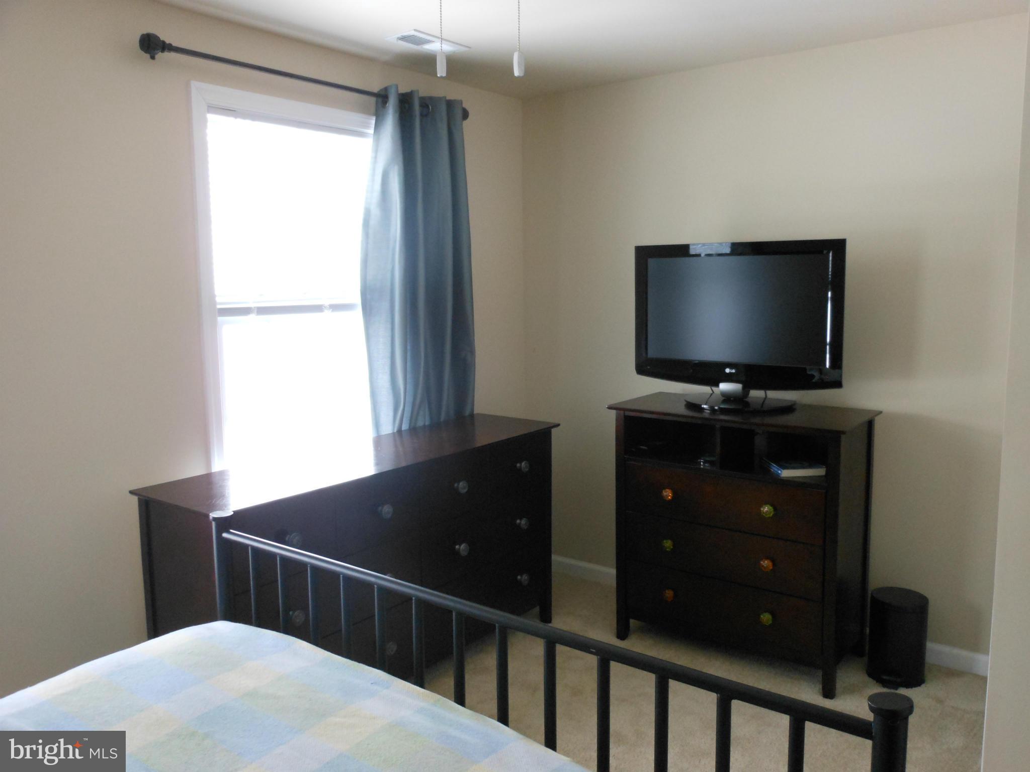8503 Golden Ridge Court Lorton, VA 22079 - Photo 15 of 27 a view of a flat screen tv and a window in a room