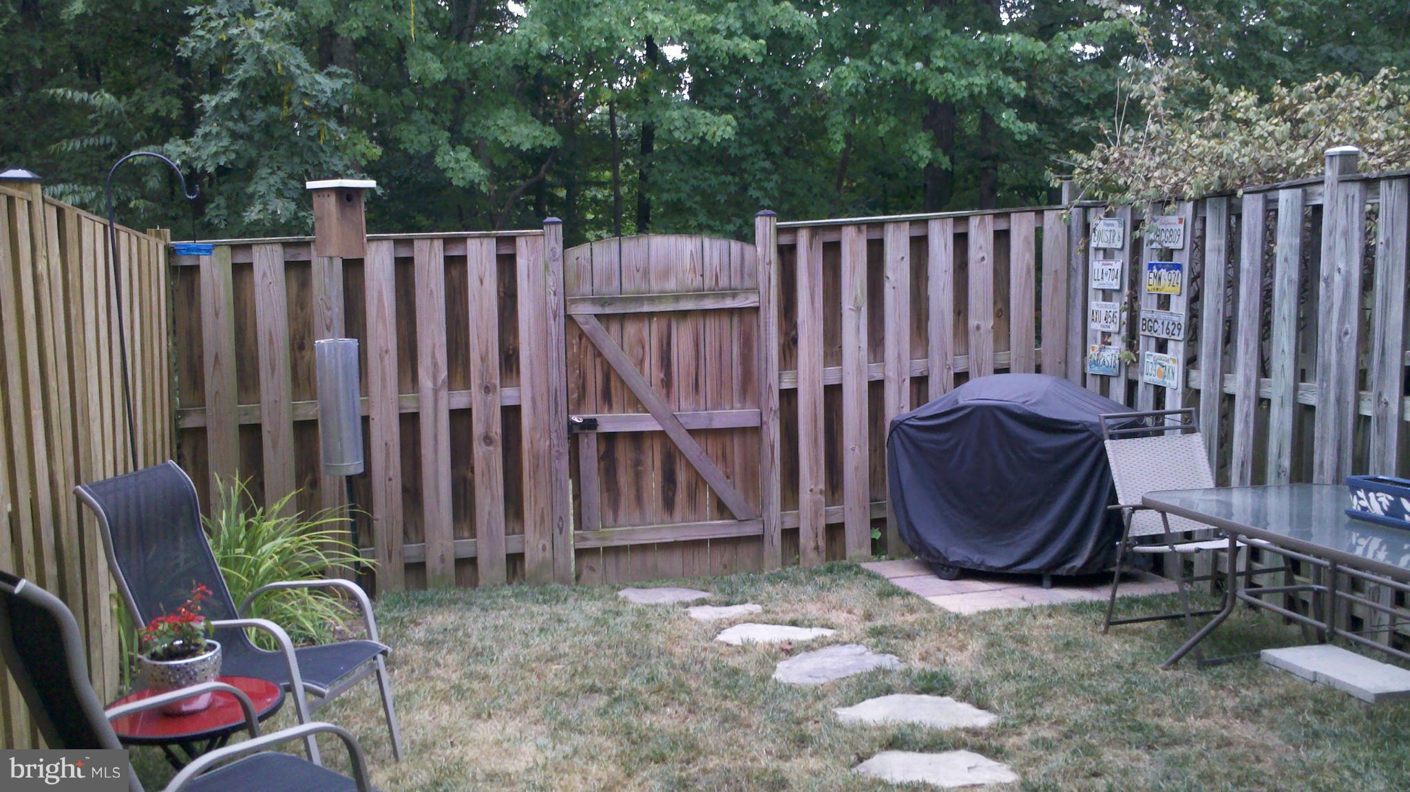 8503 Golden Ridge Court Lorton, VA 22079 - Photo 25 of 27 a wooden fence with some trees in the background