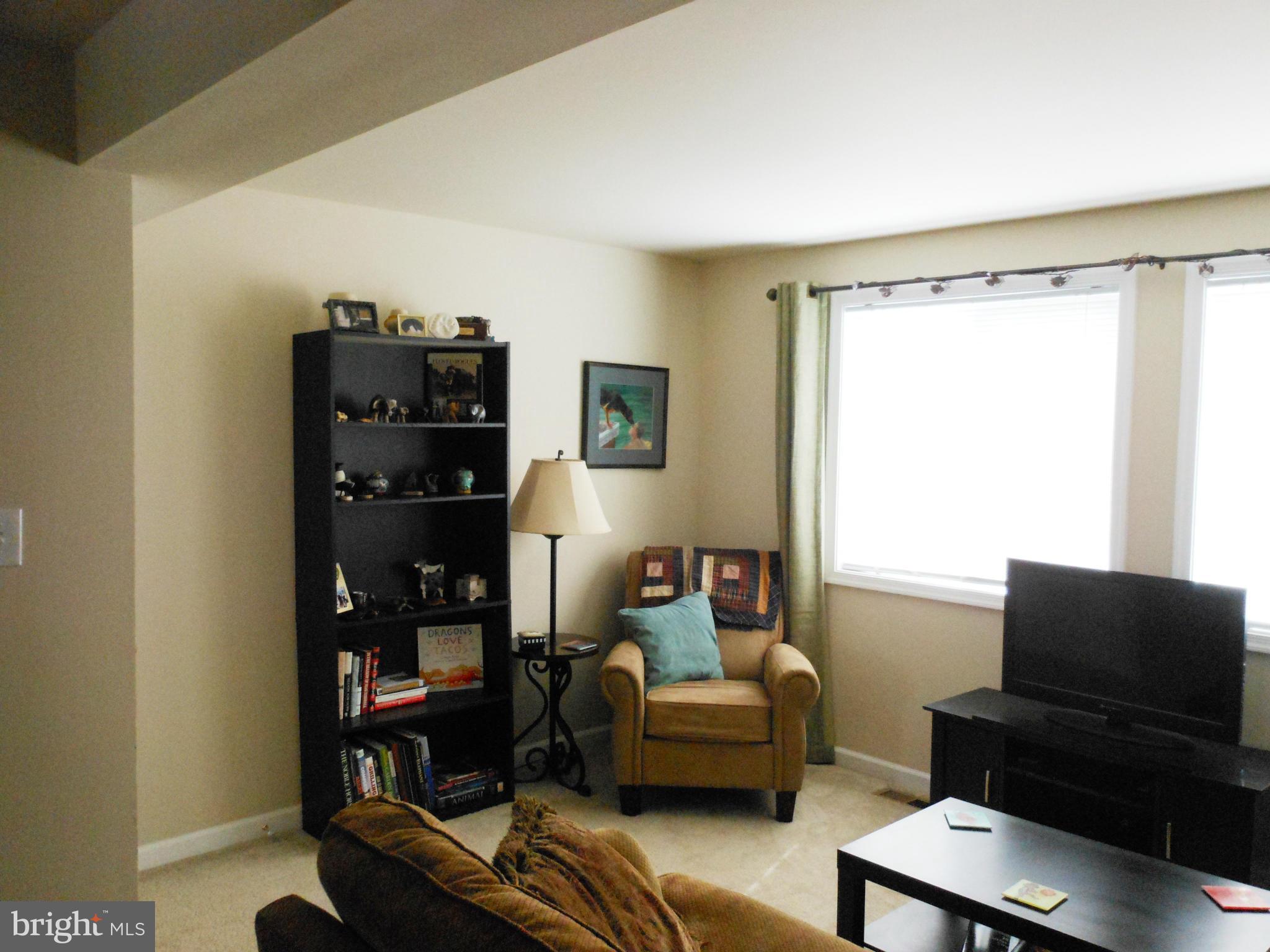 8503 Golden Ridge Court Lorton, VA 22079 - Photo 6 of 27 a living room with furniture and a flat screen tv