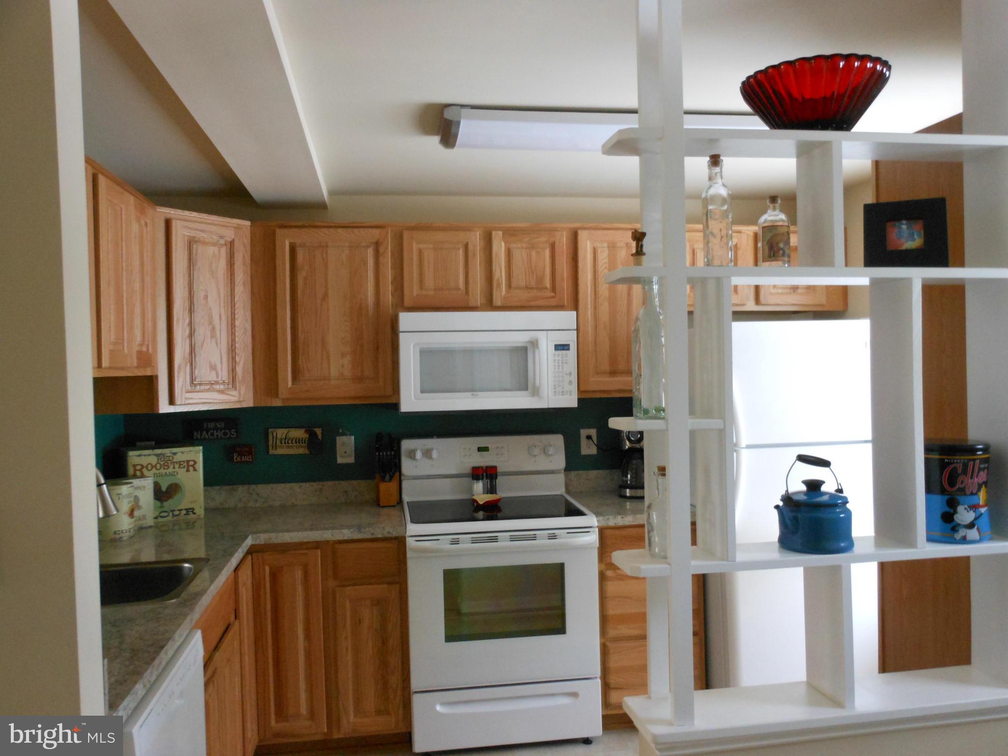 8503 Golden Ridge Court Lorton, VA 22079 - Photo 10 of 27 a kitchen with stainless steel appliances a stove a sink and a microwave