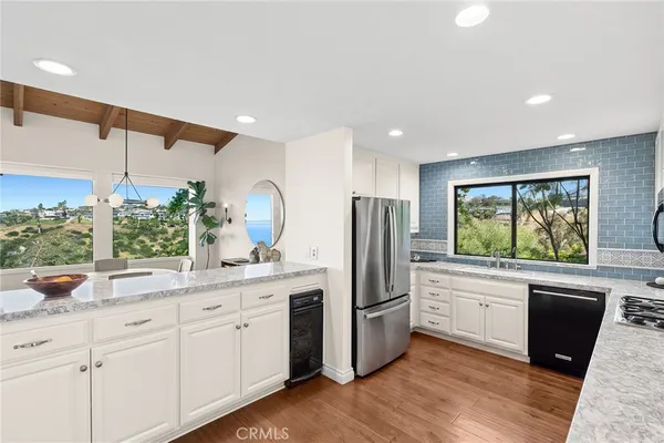 a kitchen with a refrigerator and a sink