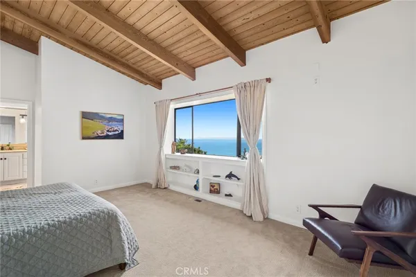 a bedroom with a bed and a chair