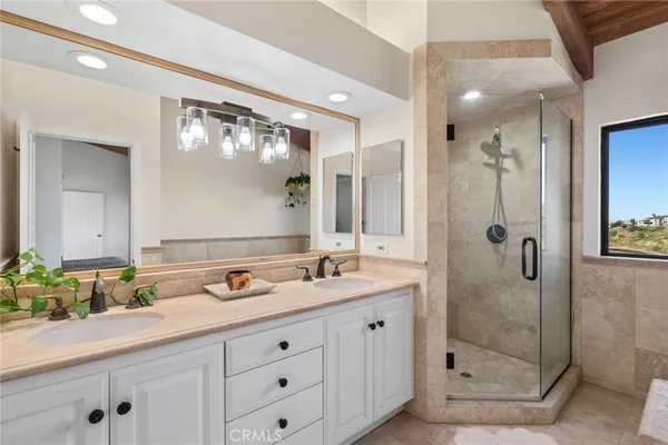 a bathroom with a shower sink and mirror