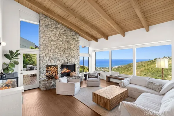 a living room with furniture fireplace and a large window