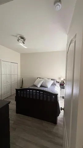 a living room with a couch and wooden floor