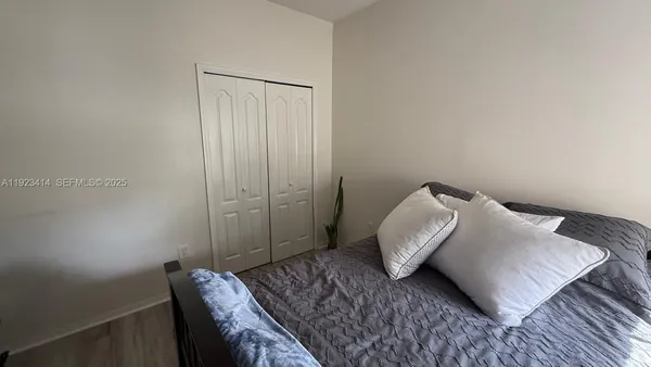 a bedroom with a bed and a chair