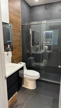 a bathroom with a sink toilet and shower