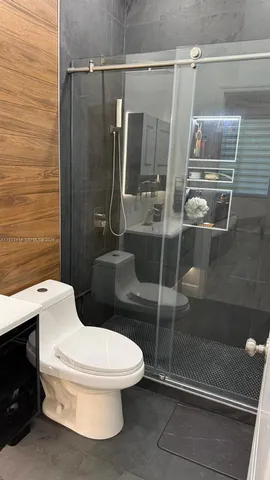a white toilet sitting next to a bathroom sink