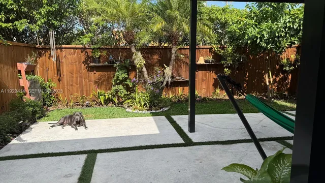 a pathway of a house and a yard with swimming pool