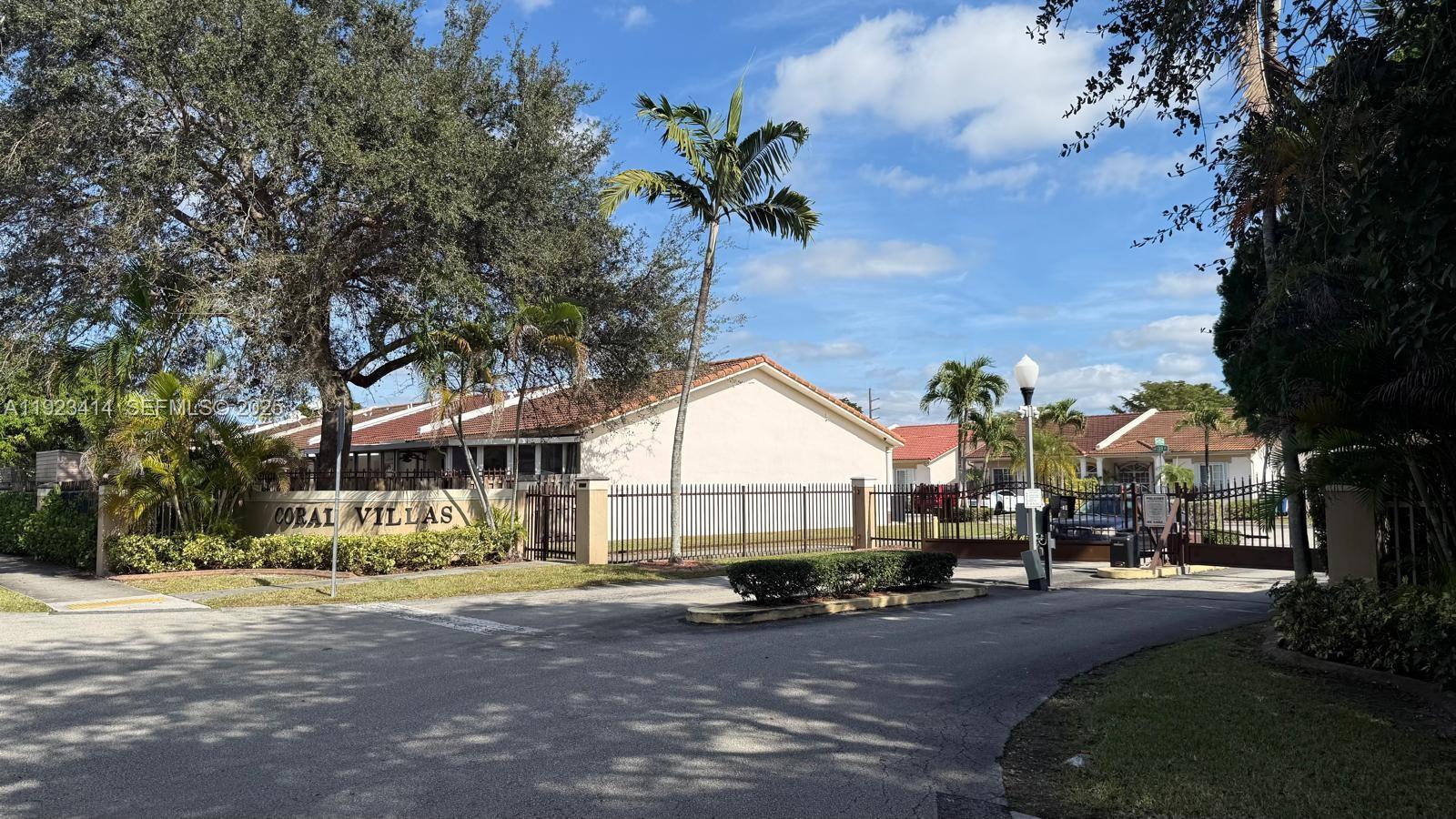 13839 Southwest 152nd Terrace Miami, FL 33177 - Photo 27 of 27 a view of a house with a large trees and table and chairs under an umbrella