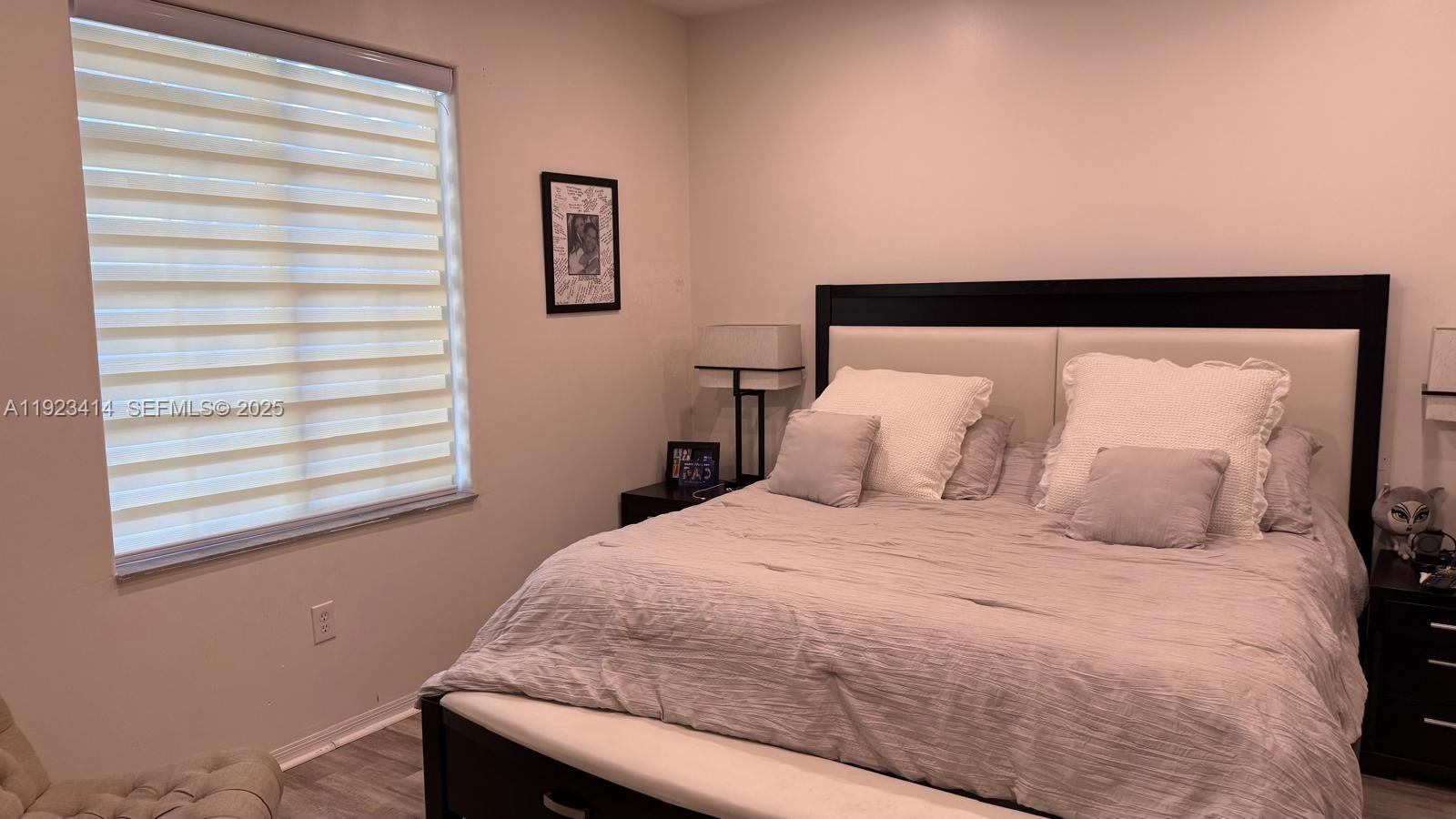 13839 Southwest 152nd Terrace Miami, FL 33177 - Photo 9 of 27 a bedroom with a bed and a window