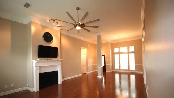 a view of a room with wooden floor and a window