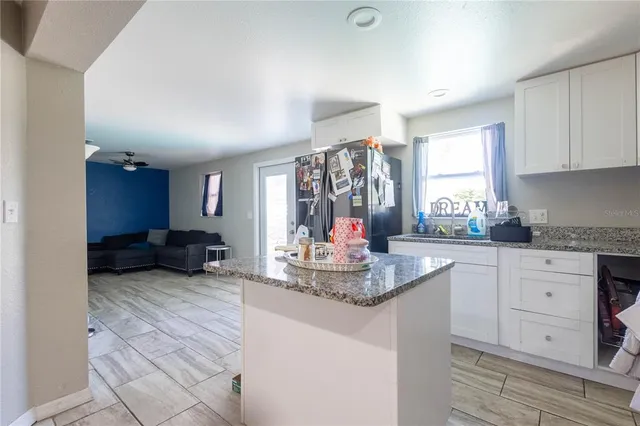 a kitchen with sink refrigerator and window