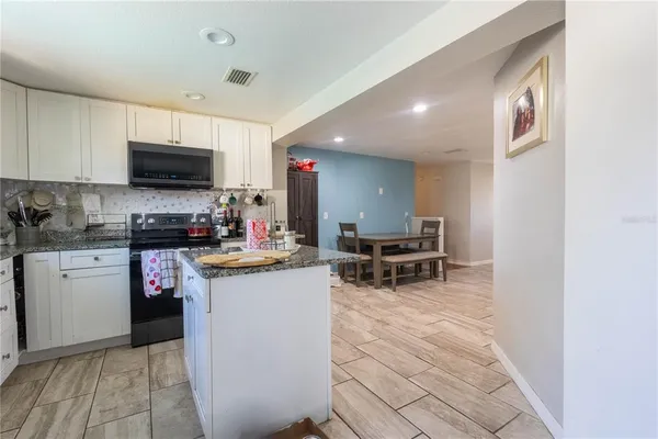 a kitchen with a sink cabinets and microwave
