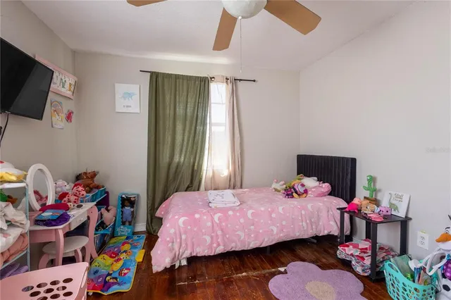 a bedroom with a bed a window and dresser