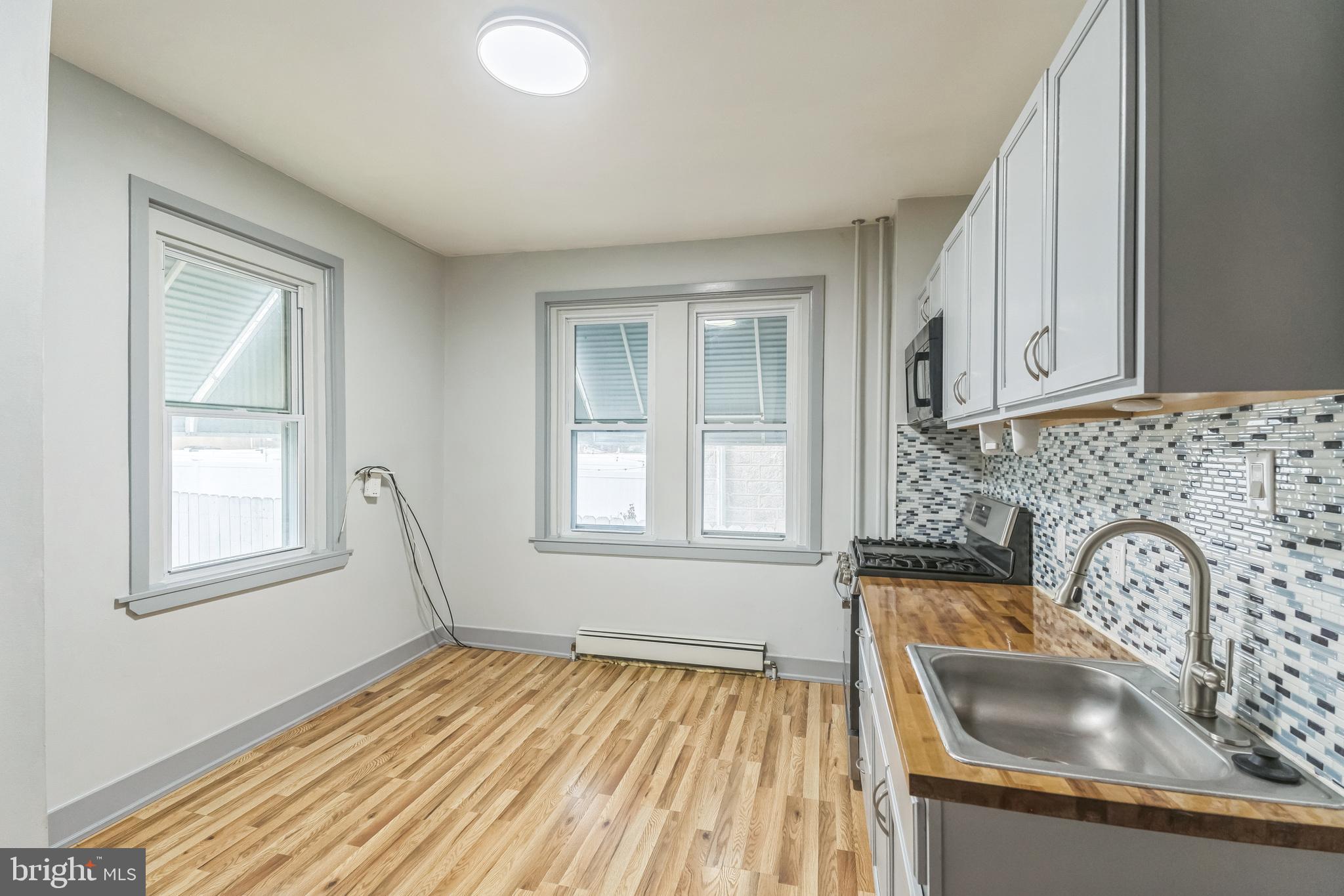 4420 Rhawn Street Philadelphia, PA 19136 - Photo 14 of 30 a kitchen with wooden cabinets and a sink