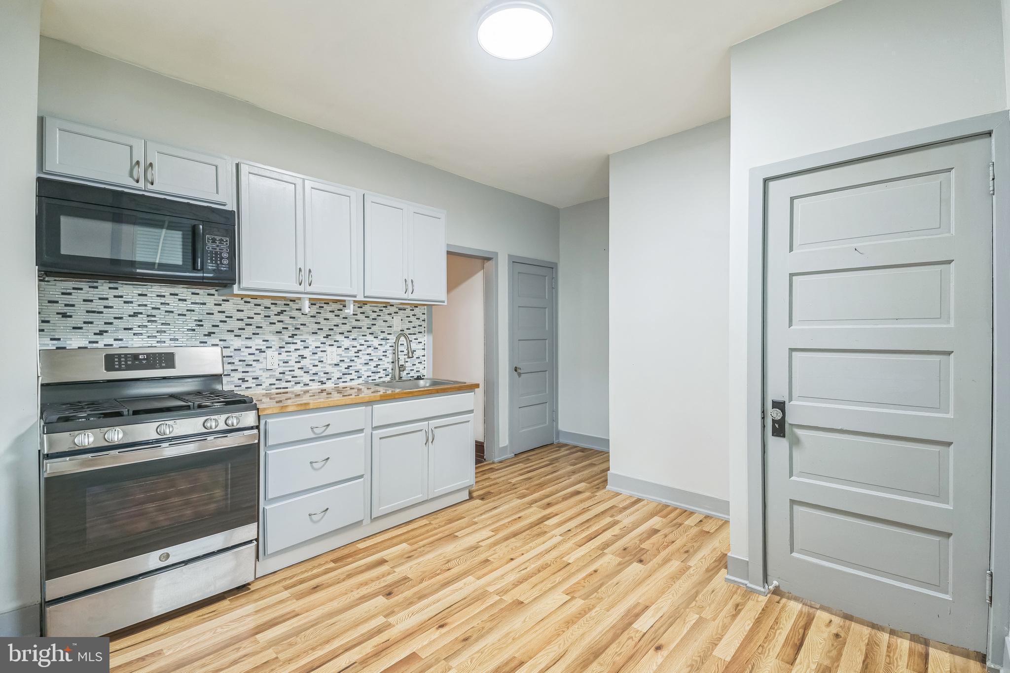 4420 Rhawn Street Philadelphia, PA 19136 - Photo 15 of 30 a kitchen with granite countertop a stove oven and a sink