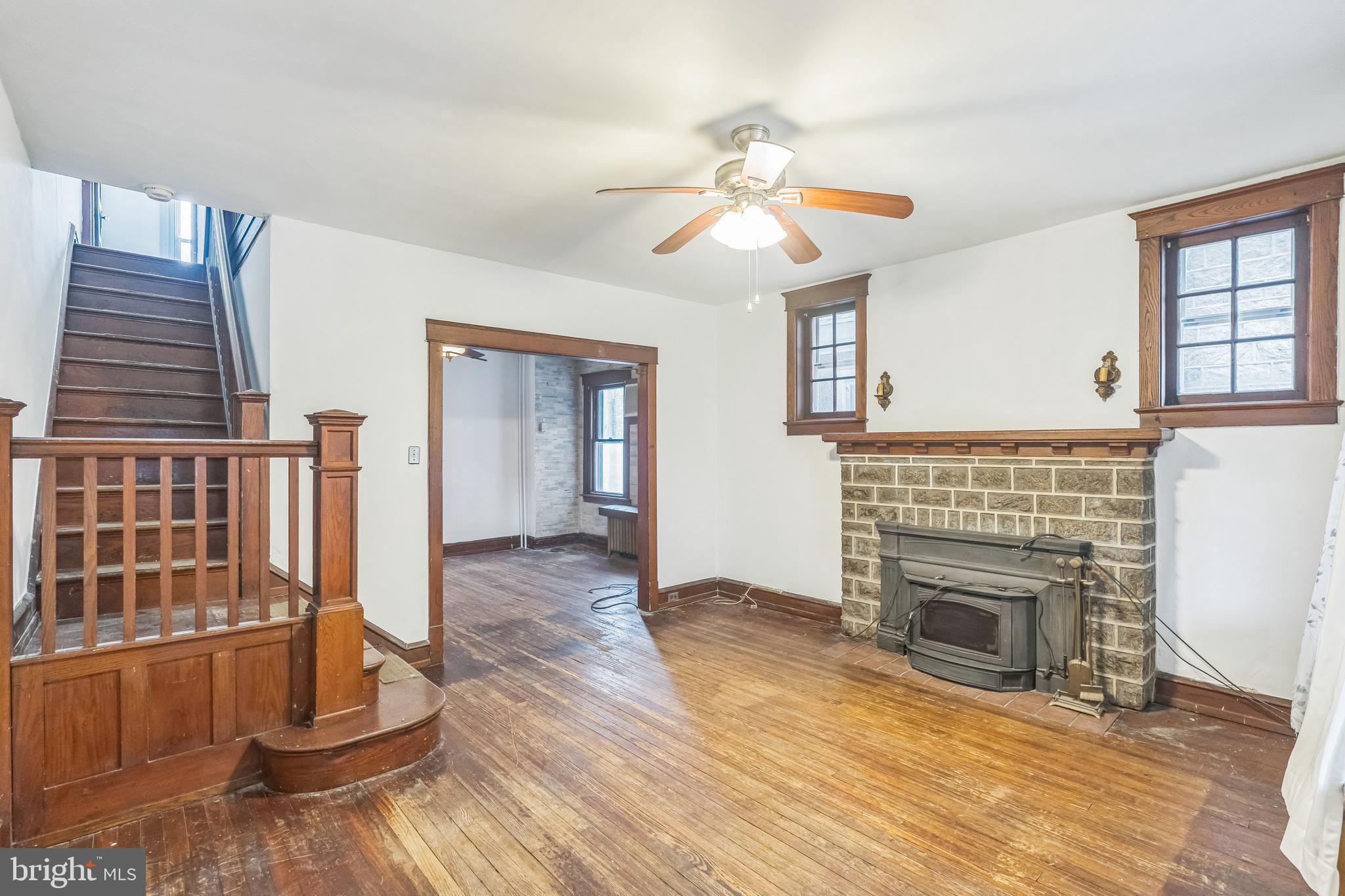 4420 Rhawn Street Philadelphia, PA 19136 - Photo 4 of 30 an empty room with wooden floor fireplace and windows