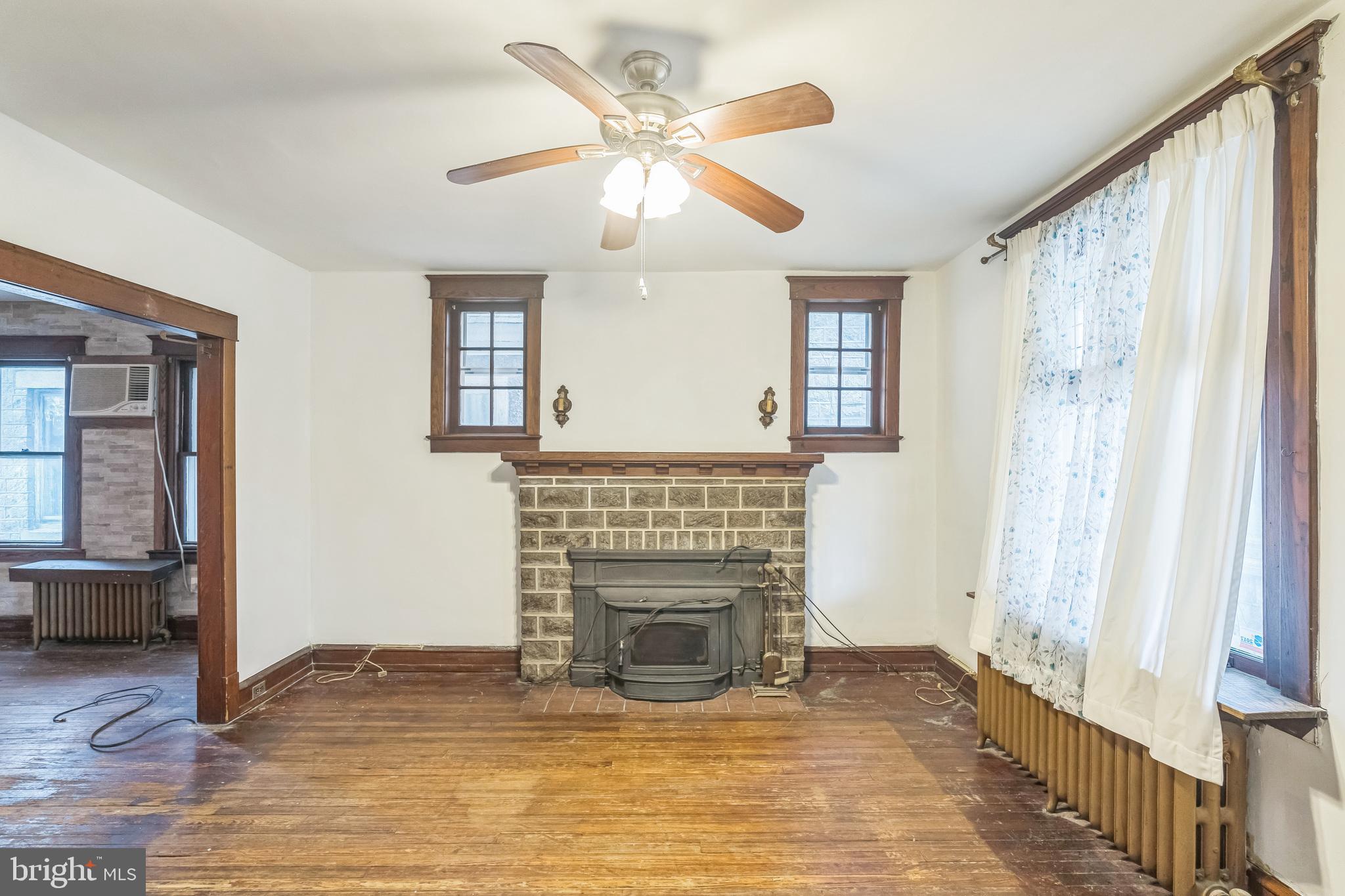 4420 Rhawn Street Philadelphia, PA 19136 - Photo 9 of 30 an empty room with windows and fireplace