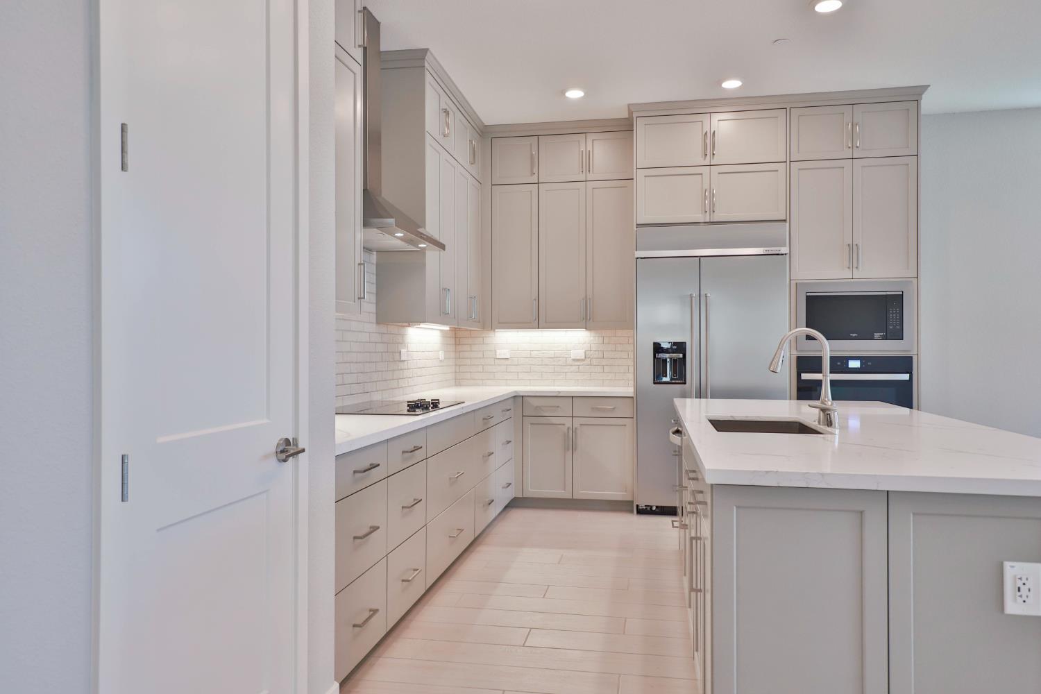 4788 Starglow Drive Penryn, CA 95663 - Photo 14 of 36 a kitchen with white cabinets and appliances
