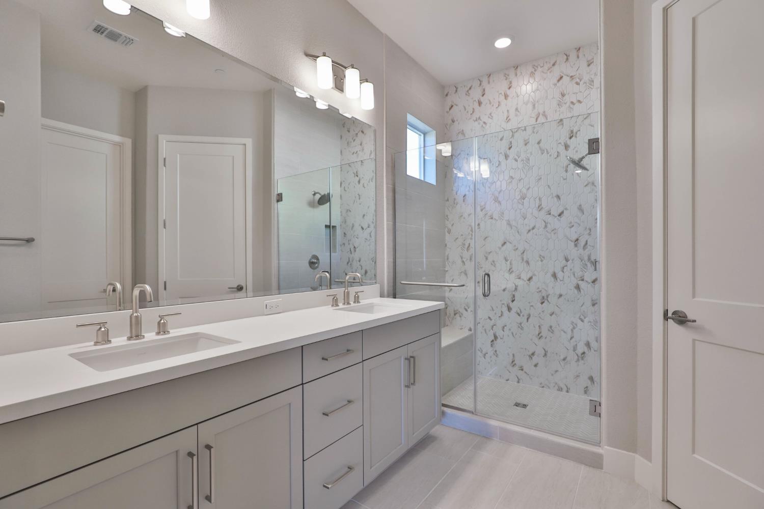 4788 Starglow Drive Penryn, CA 95663 - Photo 19 of 36 a bathroom with a double vanity sink mirror and shower