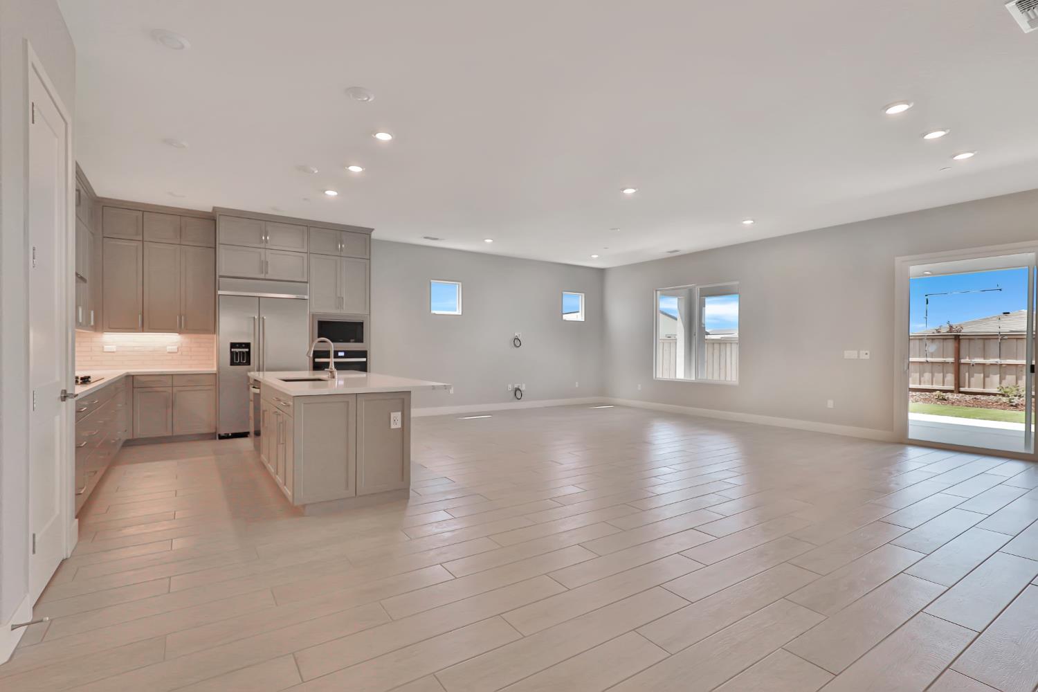 4788 Starglow Drive Penryn, CA 95663 - Photo 5 of 36 a view of open kitchen with white cabinets and wooden floor