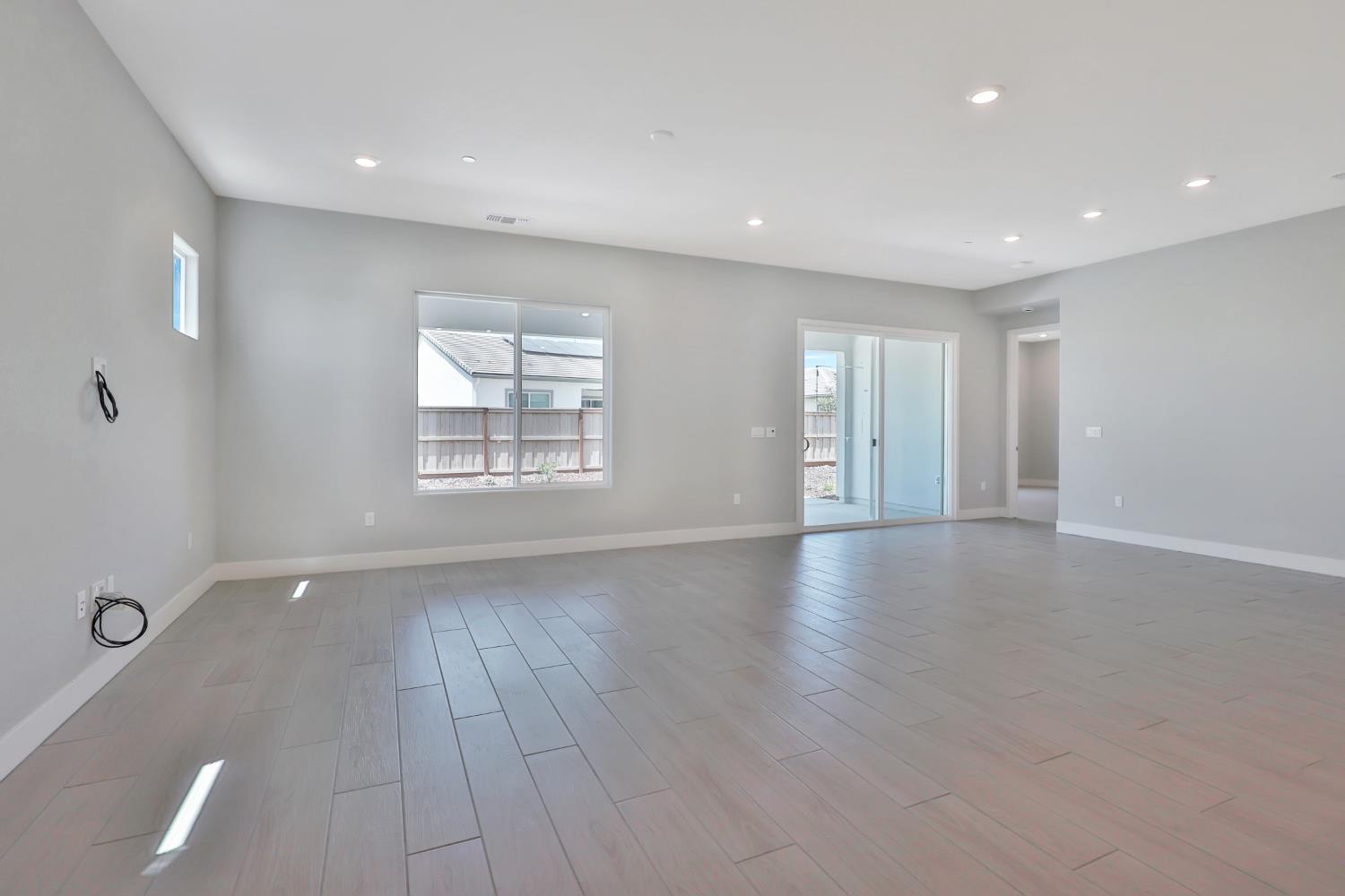 4788 Starglow Drive Penryn, CA 95663 - Photo 8 of 36 an empty room with wooden floor and windows