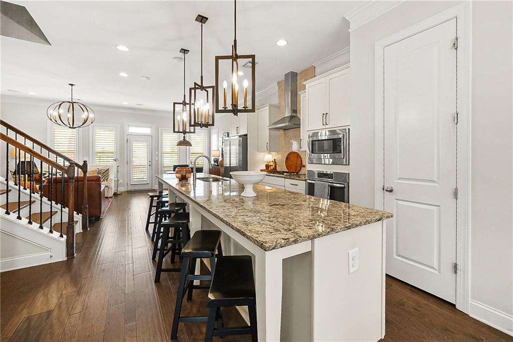 3715 Benton Lane Chamblee, GA 30341 - Photo 12 of 43 a kitchen with stainless steel appliances kitchen island granite countertop a table chairs and a refrigerator