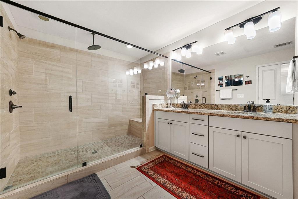 3715 Benton Lane Chamblee, GA 30341 - Photo 20 of 43 a bathroom with a granite countertop sink mirror and shower