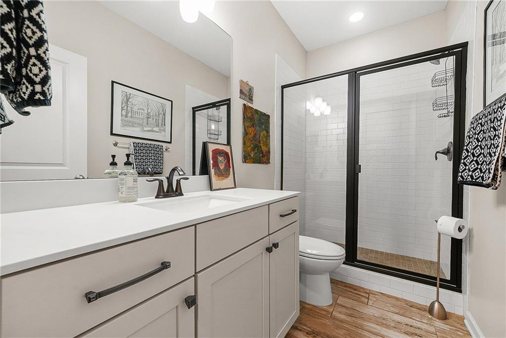 3715 Benton Lane Chamblee, GA 30341 - Photo 25 of 43 a bathroom with a sink a toilet a shower and a mirror