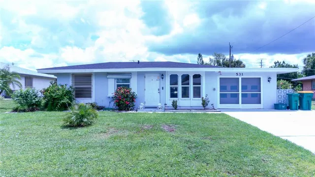 a view of a house with backyard sitting area and garden