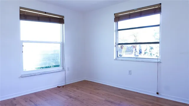 a view of an empty room and wooden floor