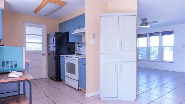 a kitchen with stainless steel appliances a refrigerator and cabinets