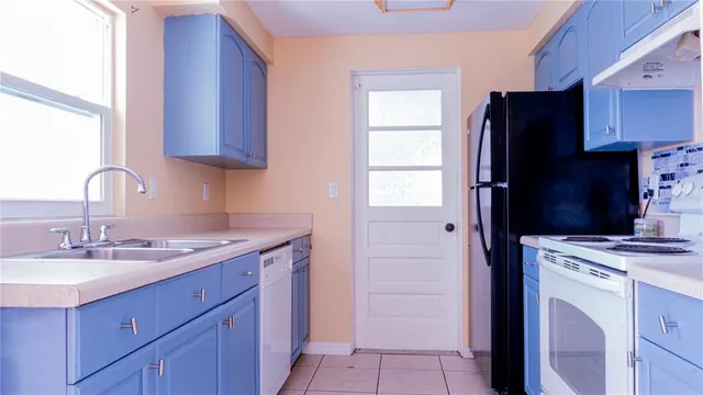 a kitchen with a sink and a refrigerator